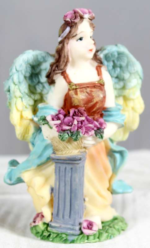 Molded small angel holding flowers
