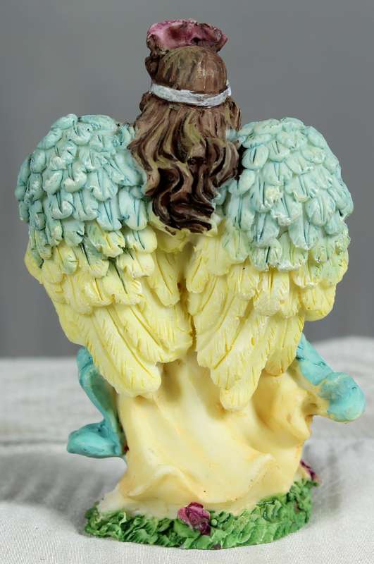 Molded small angel holding flowers