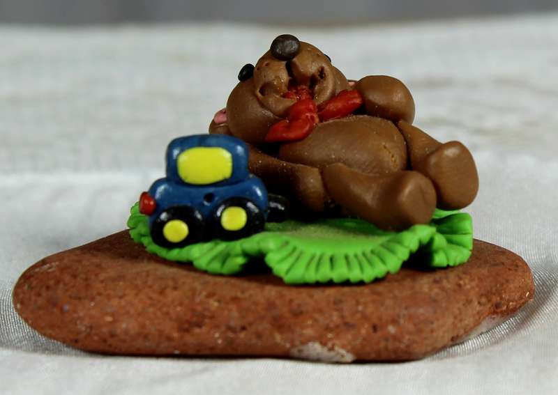 Molded miniature bear with toy car