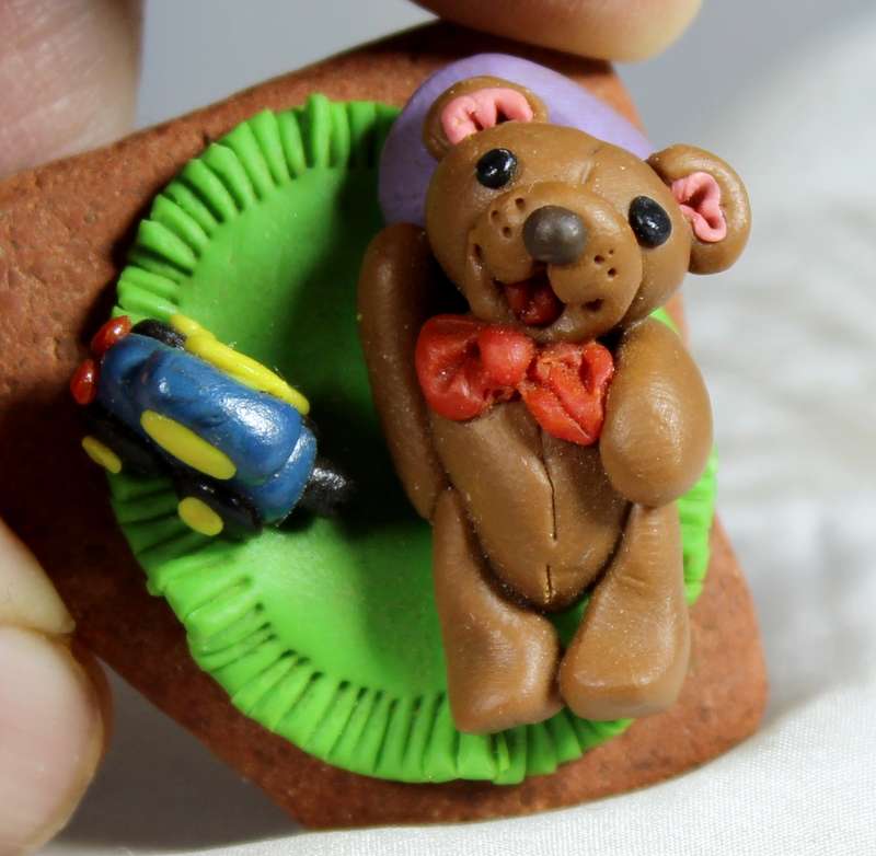 Molded miniature bear with toy car