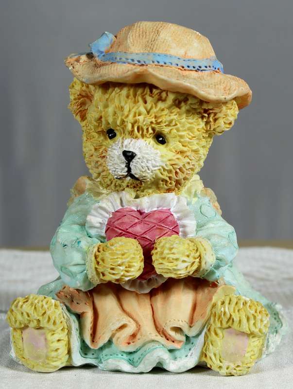 Small bear holding a large heart