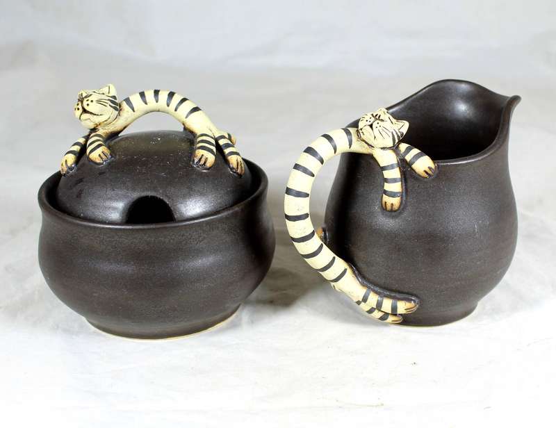 Novelty cat figurines on milk jug and sugar bowl
