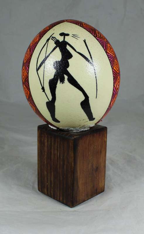 Painted ostrich egg on a wooden base