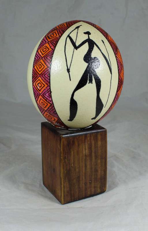 Painted ostrich egg on a wooden base