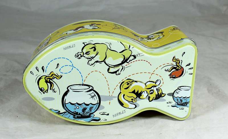 Tin in the shape of a fish with cats playing