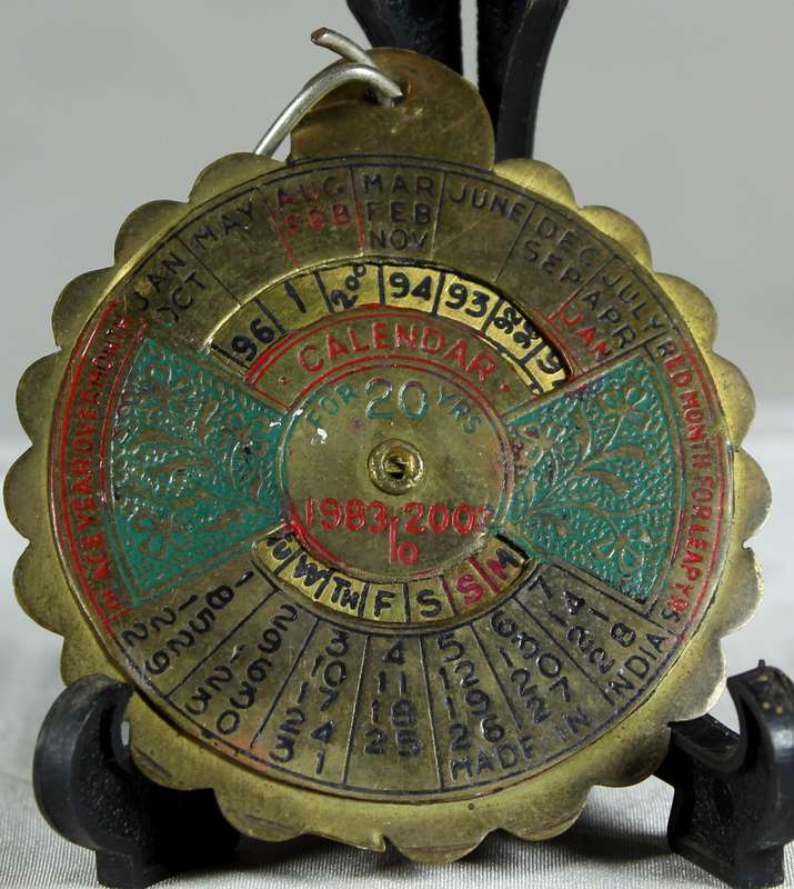 Miniature brass twenty year calander