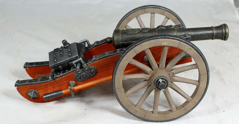 Highly detailed cannon desk lighter on wood base with ammo box