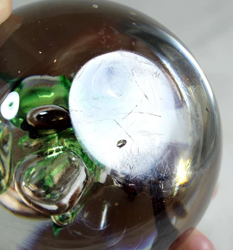 Glass paperweight with colorful bubbles