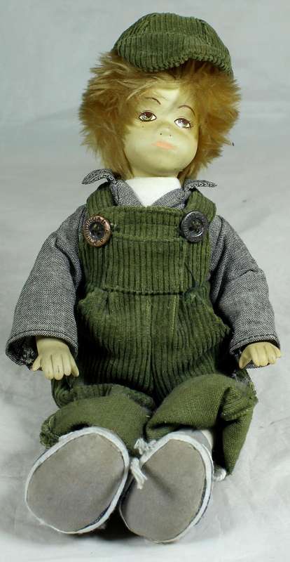 Little porcelain boy dressed in dungaree
