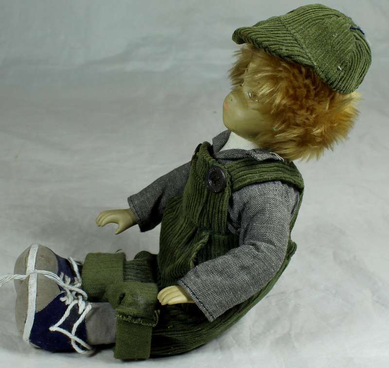 Little porcelain boy dressed in dungaree