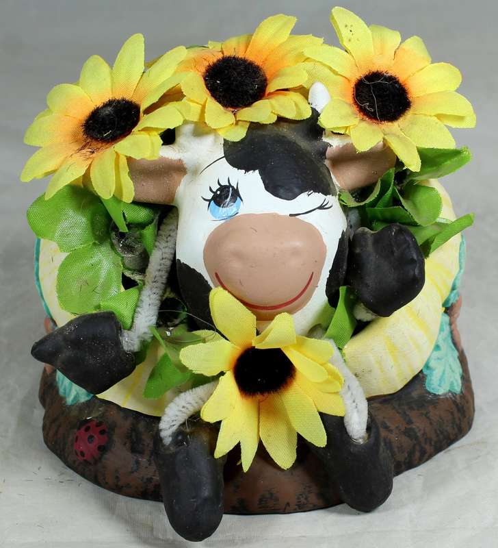 Cow in a pumpkin with sunflowers