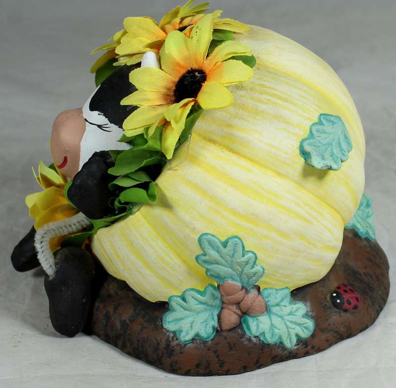 Cow in a pumpkin with sunflowers
