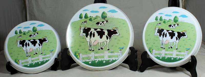 Three cow themed stove top covers