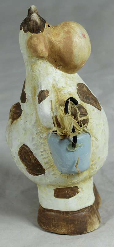 Ceramic cow holding a bucket