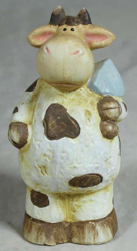 Ceramic cow holding a shovel