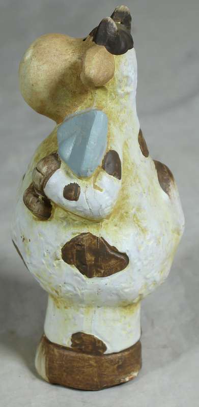 Ceramic cow holding a shovel