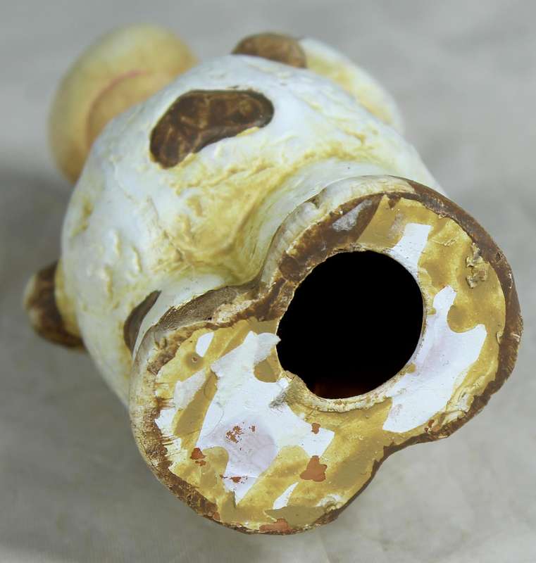 Ceramic cow holding a shovel