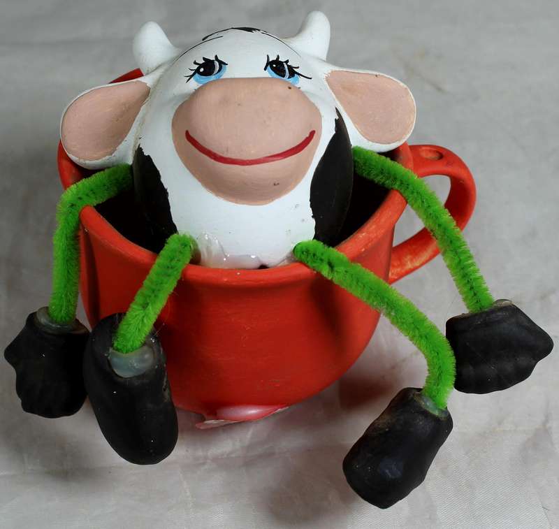 Ceramic cow in a cup