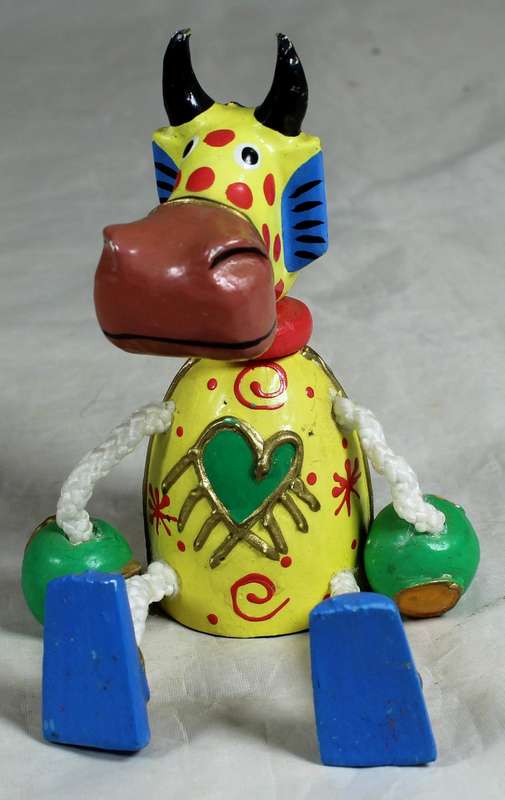 Seated funny wooden cow