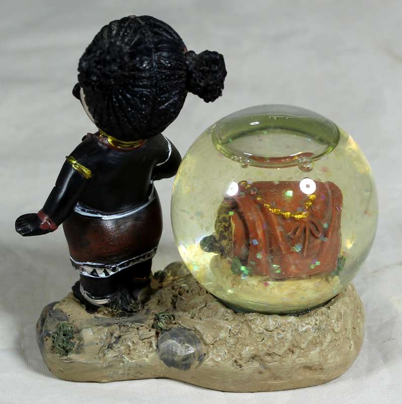 Little girl with snowglobe