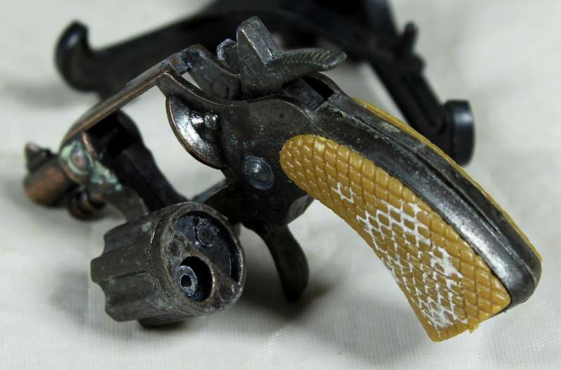 Miniature brass revolver with shooting mechanism