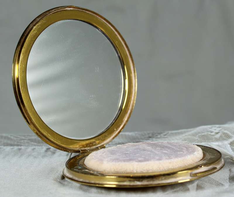 Encased flowers in golden powder compact