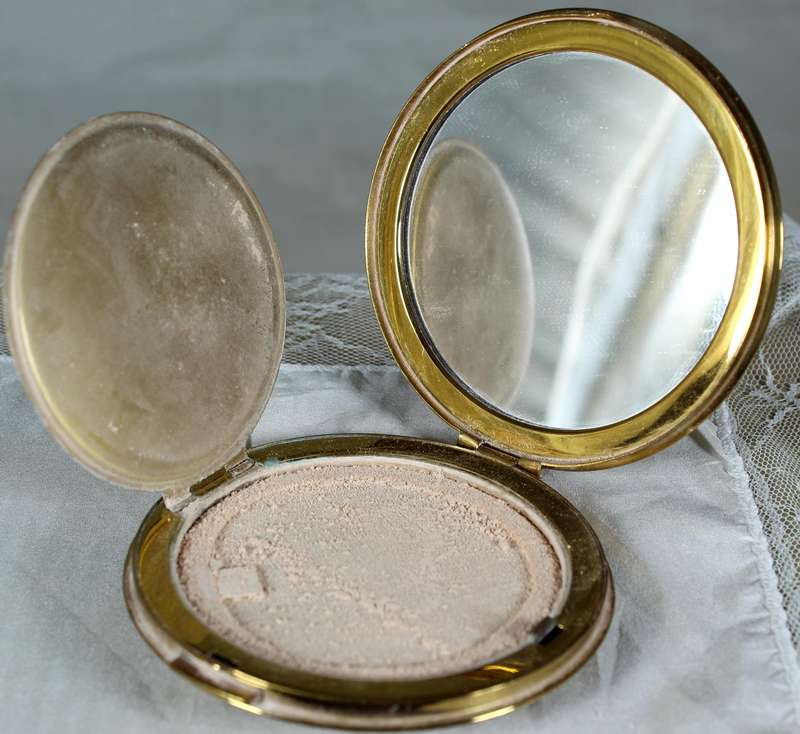 Encased flowers in golden powder compact