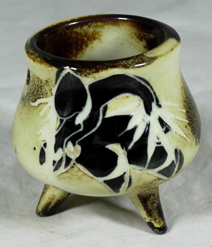Small glazed ceramic three legged pot