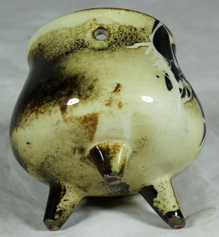 Small glazed ceramic three legged pot