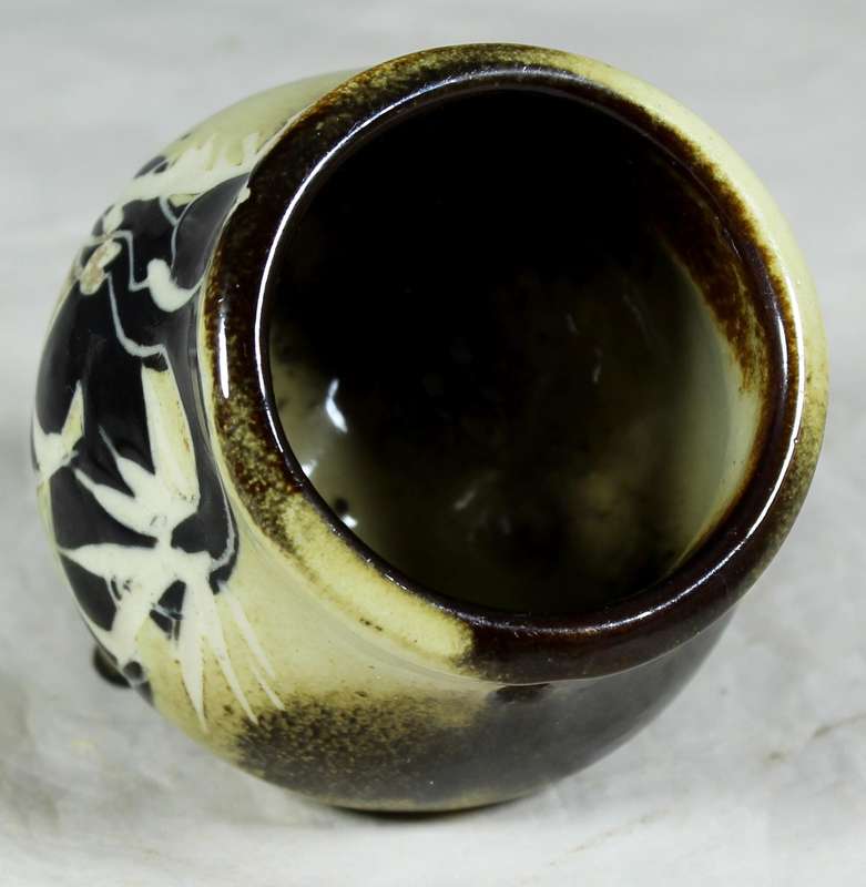 Small glazed ceramic three legged pot