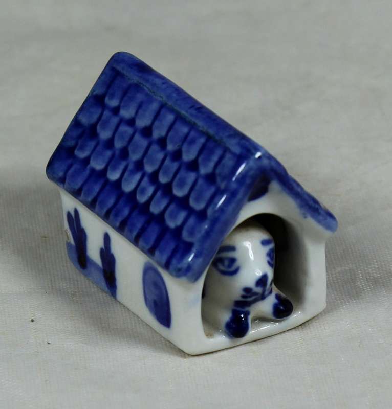 Miniature dog in a doghouse