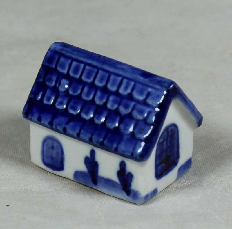 Miniature dog in a doghouse