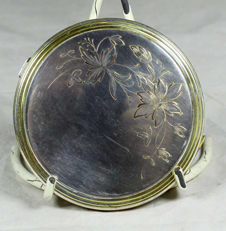 Large silver look powder compact with engraving
