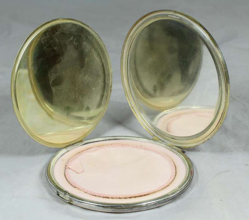 Large silver look powder compact with engraving