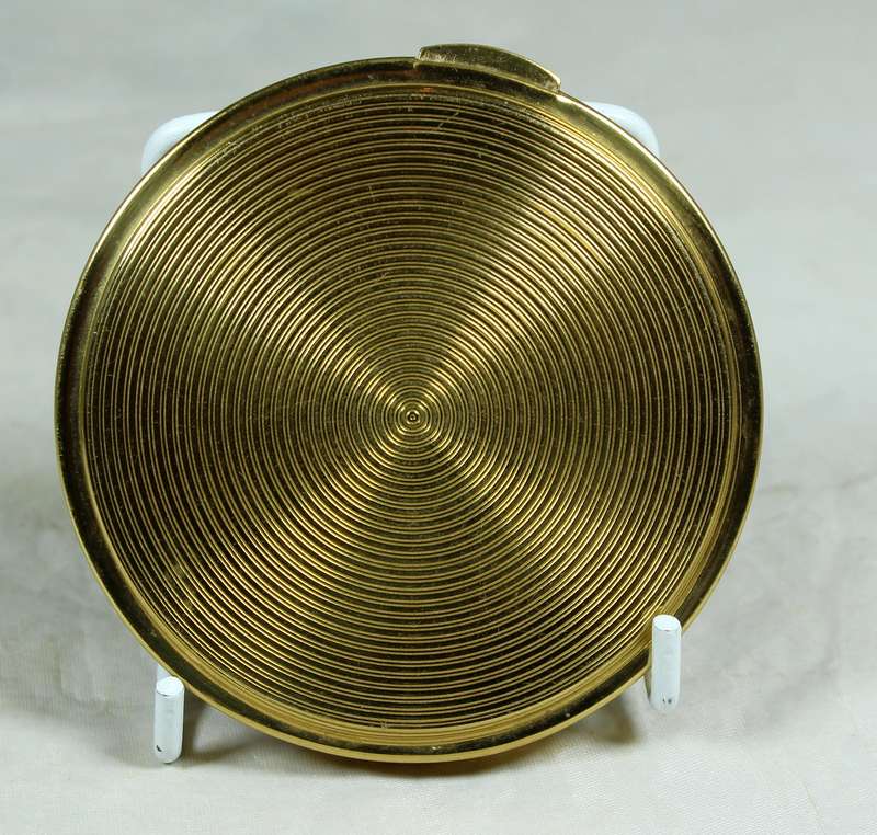 Gold tone powder compact