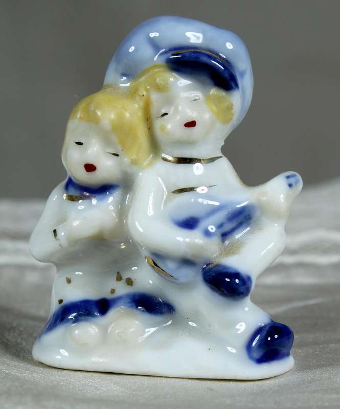 Miniature porcelain singing boy and girl