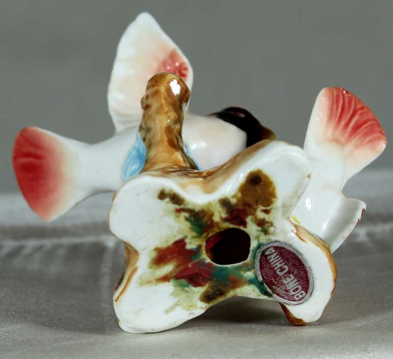 Miniature porcelain pair of birds on a stand