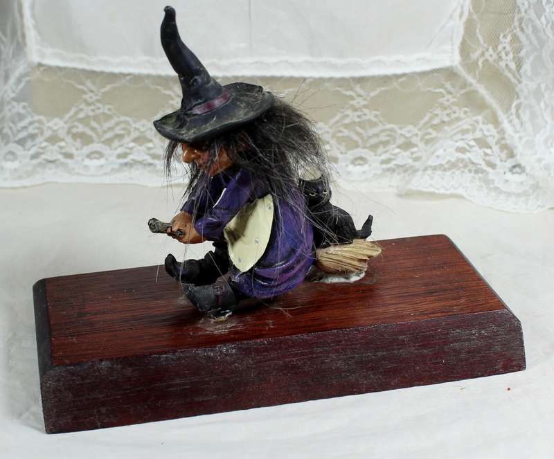 Witch riding a broom - small, on a wood plinth
