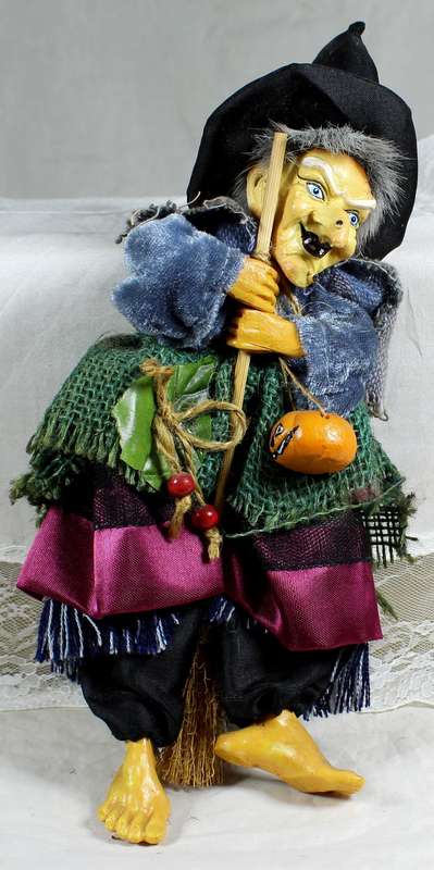 Halloween witch with broom and pumpkin