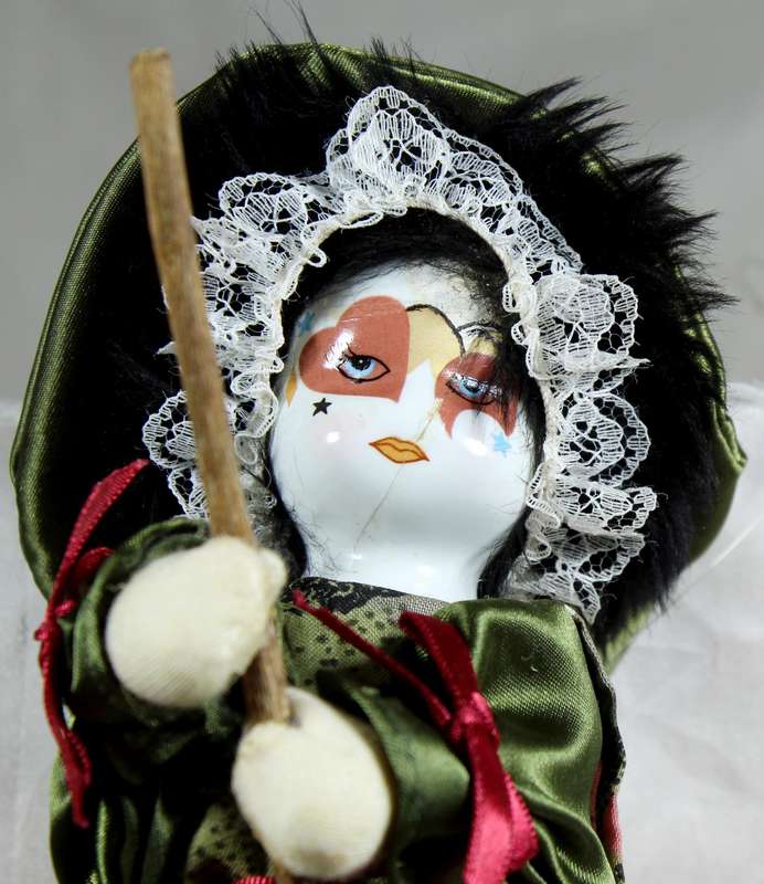 Witch riding a broom - porcelain face