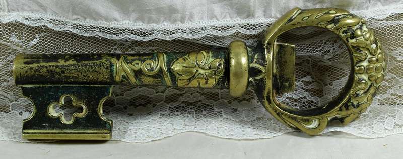 Key shaped brass bottle opener and corkscrew