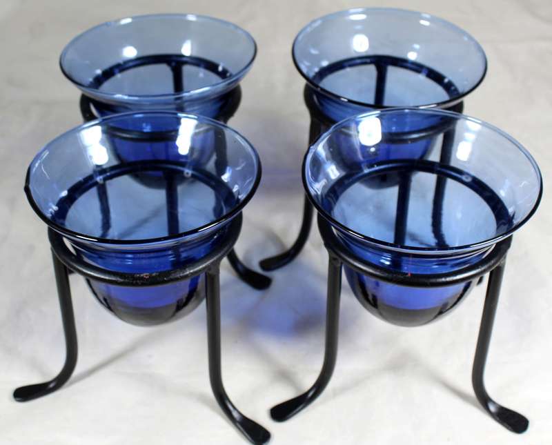 Set of four blue vases on stands