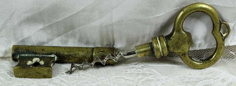 Bronze key bottle opener with cork puller