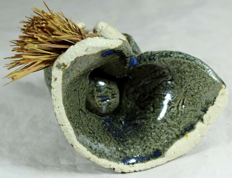 Pottery witch with broom in green coat
