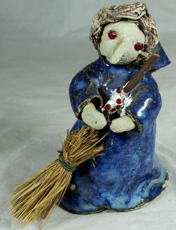 Pottery witch with broom in blue coat