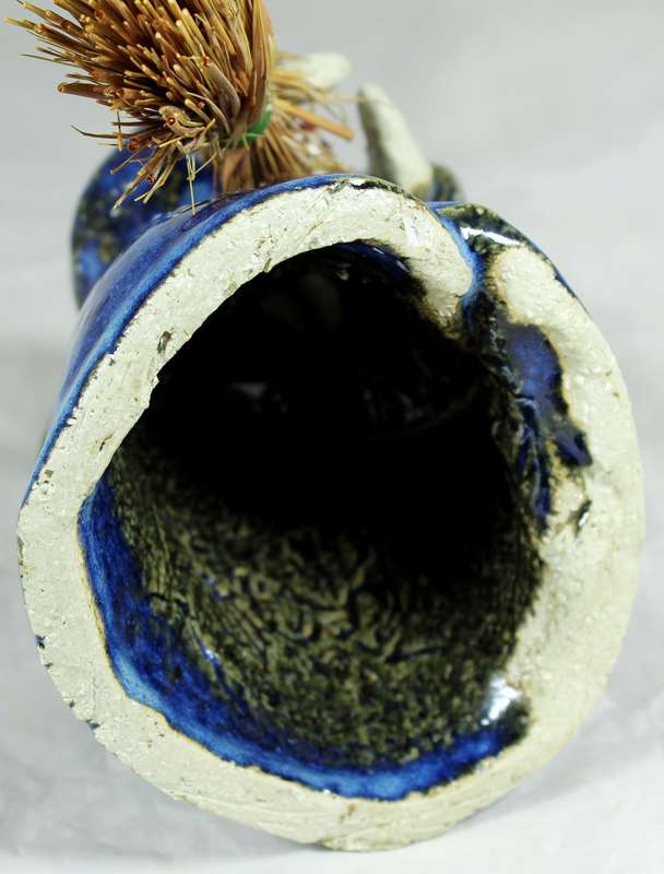 Pottery witch with broom in blue coat