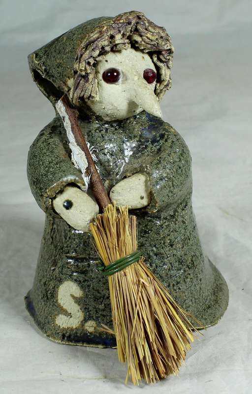 Pottery witch with broom in green coat