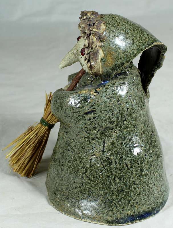 Pottery witch with broom in green coat