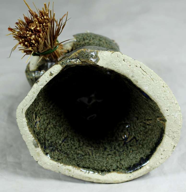 Pottery witch with broom in green coat