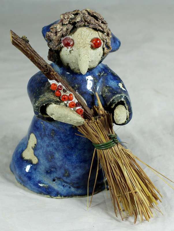 Pottery witch with broom in blue coat